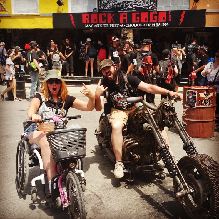 Audrey, user of our handbikes, with her companion at the Hellfest Festival, an accessible festival for people with reduced mobility. Audrey, user of our handbikes, with her companion at the Hellfest Festival, an accessible festival for people with reduced mobility.